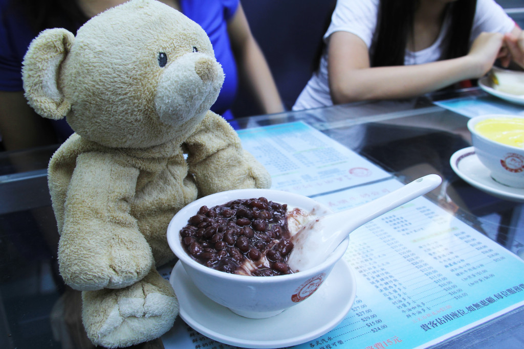 Cold milk pudding with red bean on top.