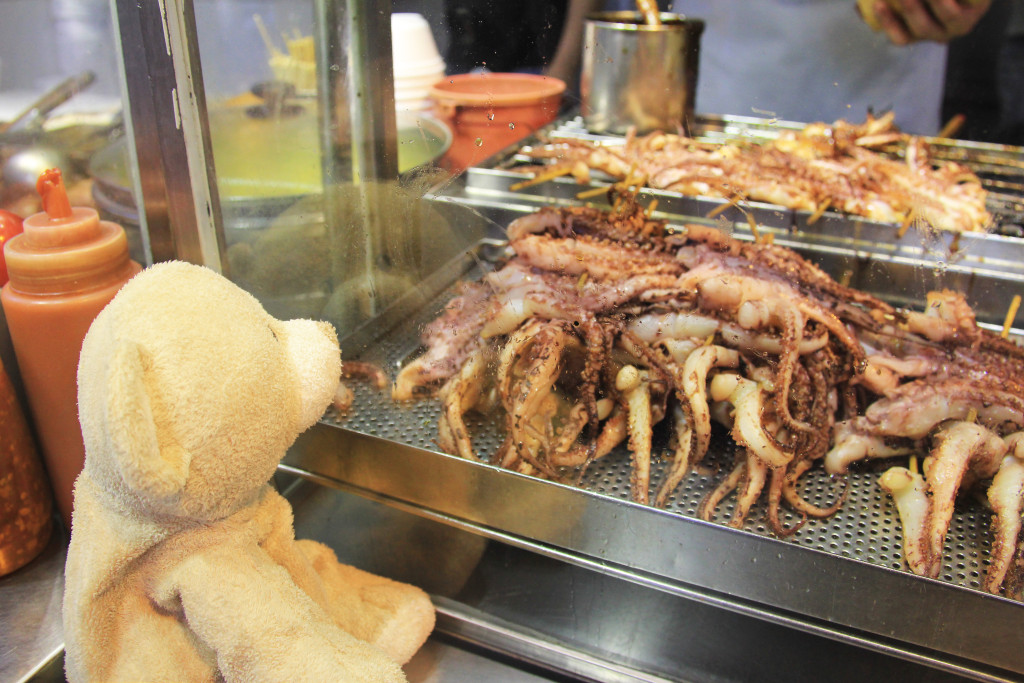 Woody admiring yummy squid legs.