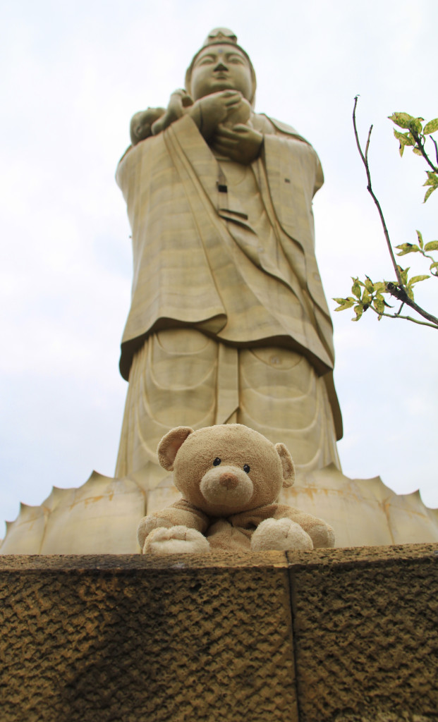 The tall Kannon statue looming over Woody.